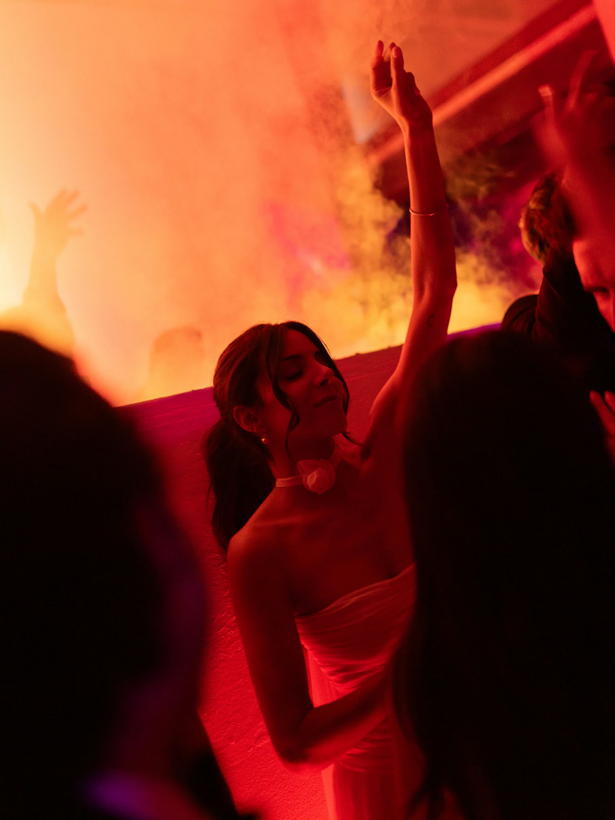 Dance floor washed in red light at a vbmusic party